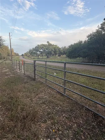a view of a yard with wooden fence