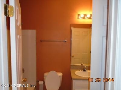 4681 Barnes Road South Jacksonville, FL 32207 - Photo 12 of 15 a bathroom with a toilet a sink and mirror