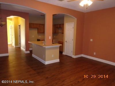 4681 Barnes Road South Jacksonville, FL 32207 - Photo 14 of 15 a view of a hallway with wooden floor and a chandelier