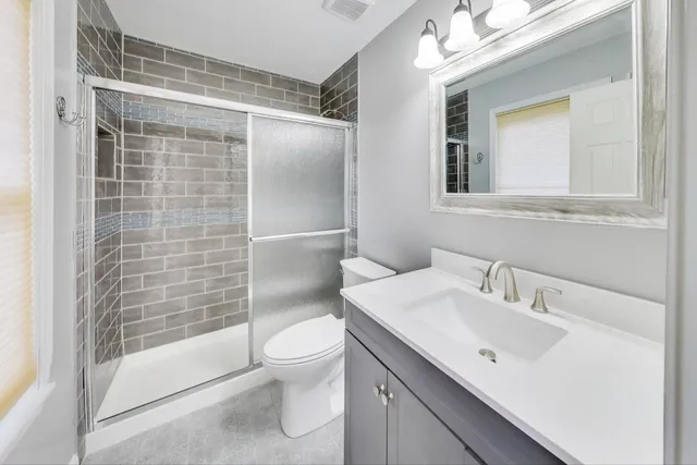 a bathroom with a sink toilet and shower