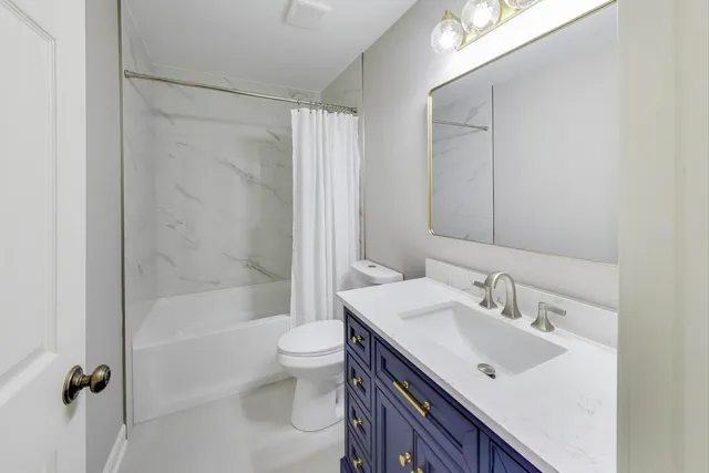 a bathroom with a sink mirror toilet and bathtub