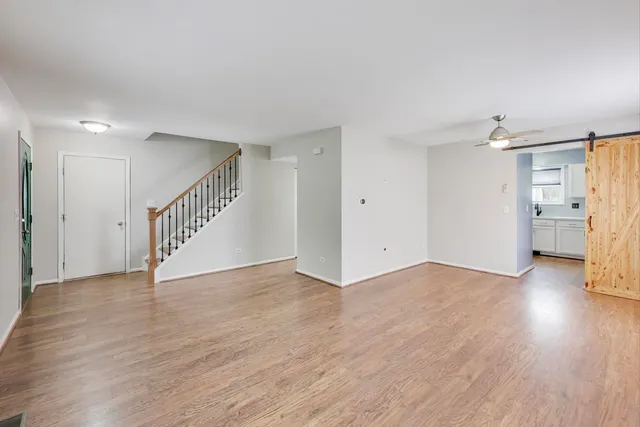 a view of an empty room with wooden floor