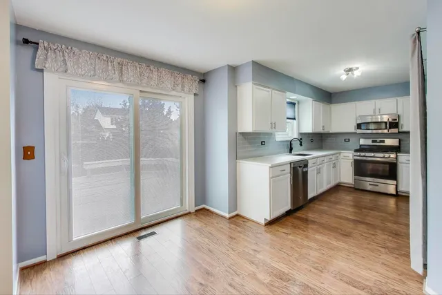 a kitchen with a stove a sink and a refrigerator