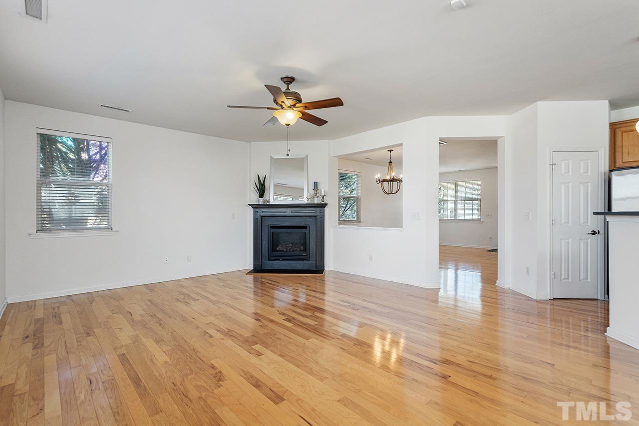 109 Poppy Hills Court Raleigh, NC 27603 - Photo 7 of 30 a view of an empty room with window and wooden floor