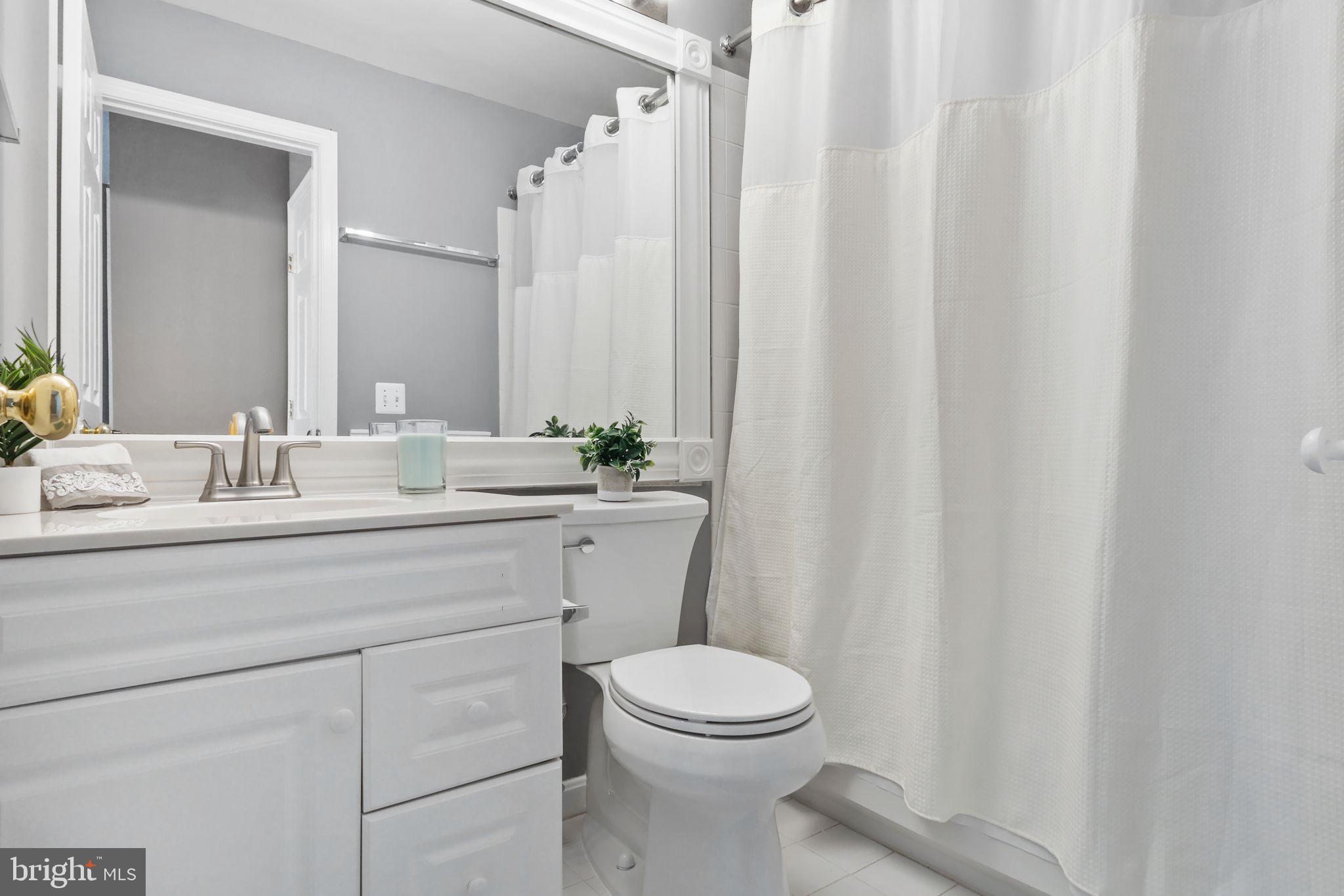 6038 Lincolnia Road Alexandria, VA 22312 - Photo 19 of 31 a bathroom with a sink a toilet and shower curtain