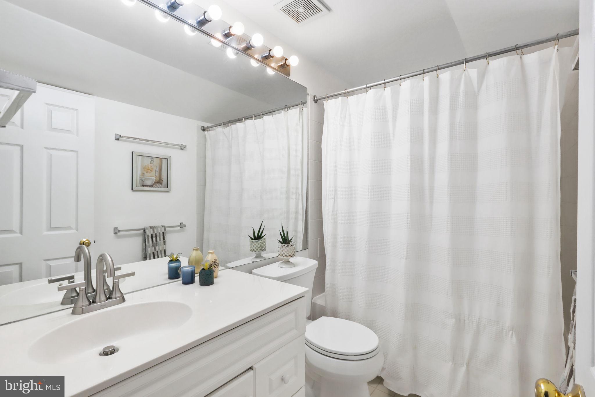 6038 Lincolnia Road Alexandria, VA 22312 - Photo 23 of 31 a bathroom with a sink a toilet and shower curtain