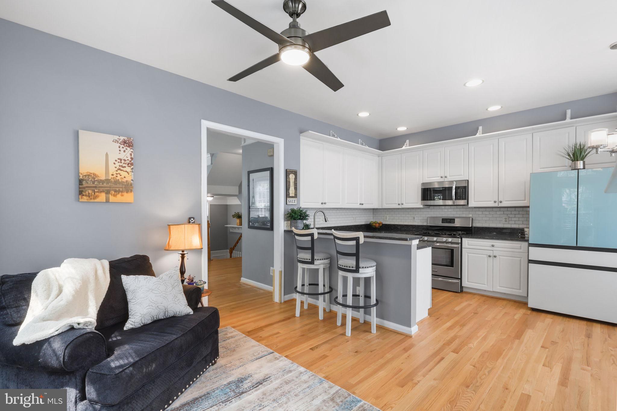 6038 Lincolnia Road Alexandria, VA 22312 - Photo 8 of 31 a living room with stainless steel appliances kitchen island granite countertop furniture wooden floor and a kitchen view