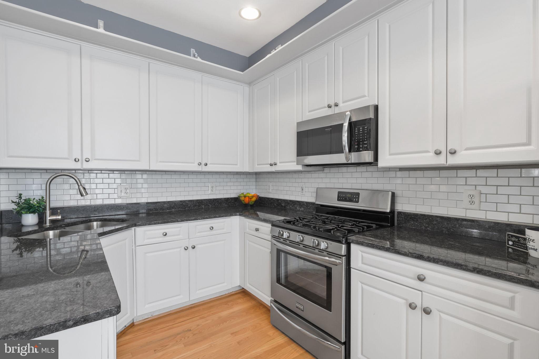 6038 Lincolnia Road Alexandria, VA 22312 - Photo 10 of 31 a kitchen with granite countertop white cabinets and stainless steel appliances