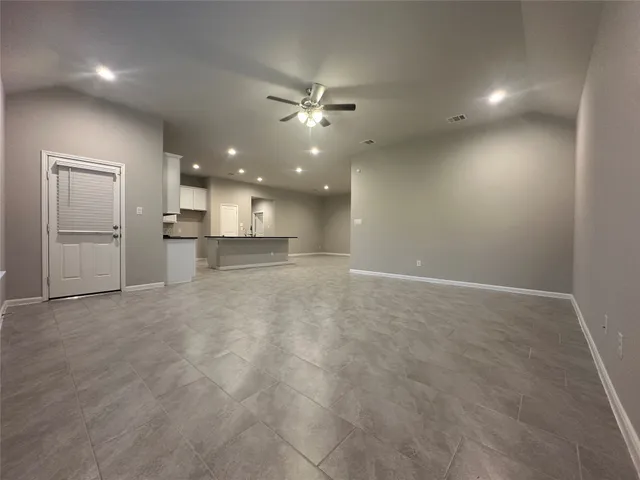 an empty room with closet and windows