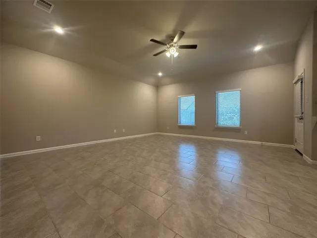 a view of a livingroom with a ceiling fan and window