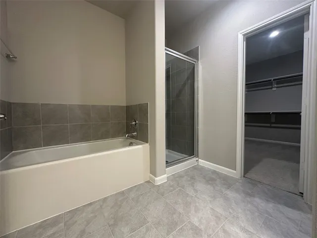 a bathroom with a bathtub and a shower