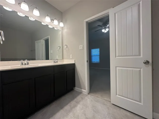 a bathroom with a double vanity sink and a mirror