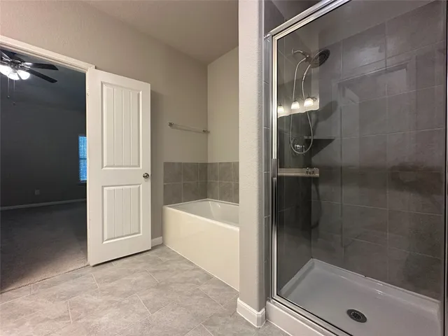 a bathroom with a bathtub and a shower