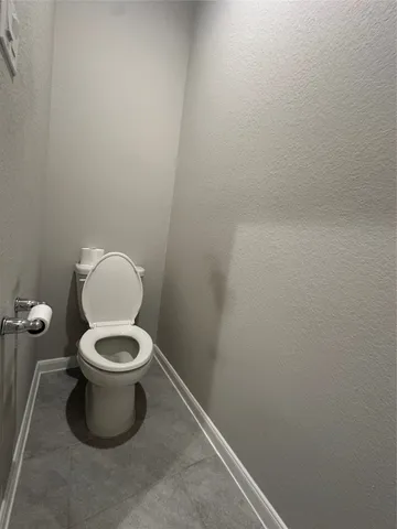 a white toilet sitting in a bathroom