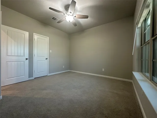an empty room with a view of a livingroom