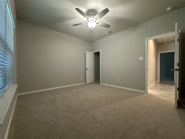 a view of a livingroom with a ceiling fan and window