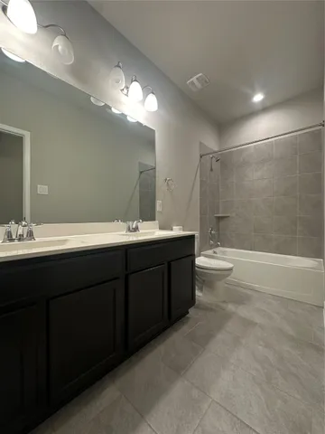 a bathroom with a double vanity sink mirror double and shower