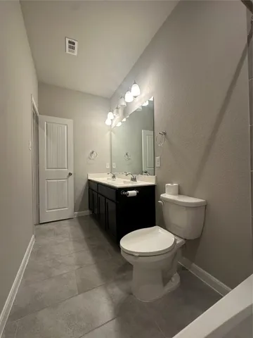 a bathroom with a sink toilet and a mirror