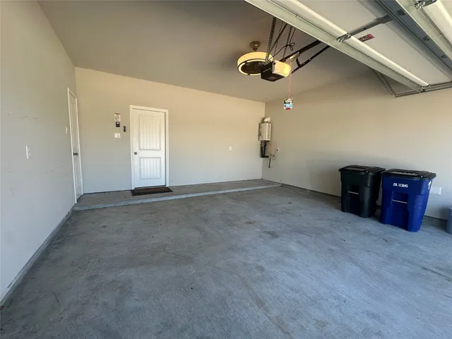 an empty room with a ceiling fan and wooden floor