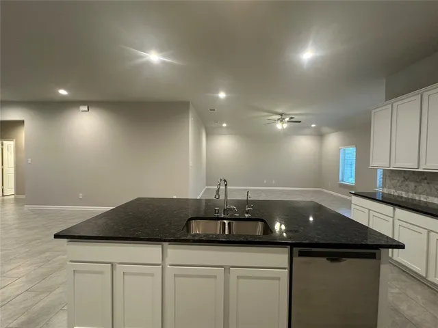 a kitchen with a sink and cabinets