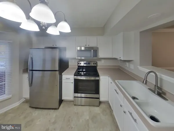 a kitchen with a sink and a refrigerator