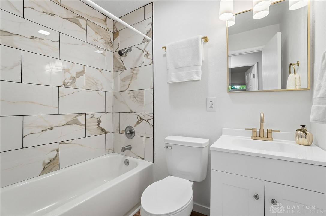 1923 Portage Path Springfield, OH 45506 - Photo 27 of 40 A well-appointed bathroom offers sleek tiling and a modern vanity for everyday comfort.