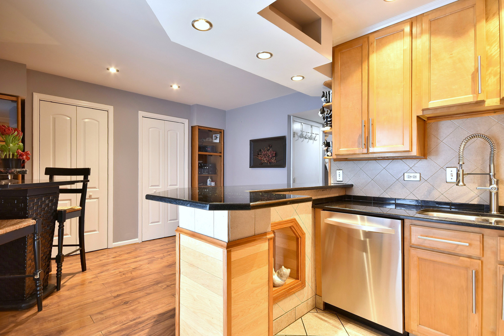 260 Rodenburg Road Roselle, IL 60172 - Photo 16 of 39 a kitchen with stainless steel appliances granite countertop a sink and wooden cabinets