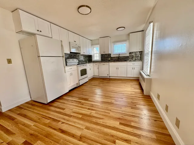 a kitchen with stainless steel appliances a refrigerator and a stove top oven