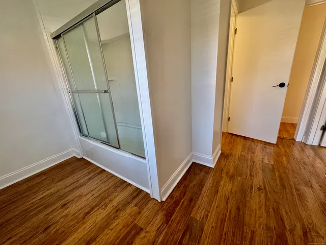 a view of front door with wooden floor