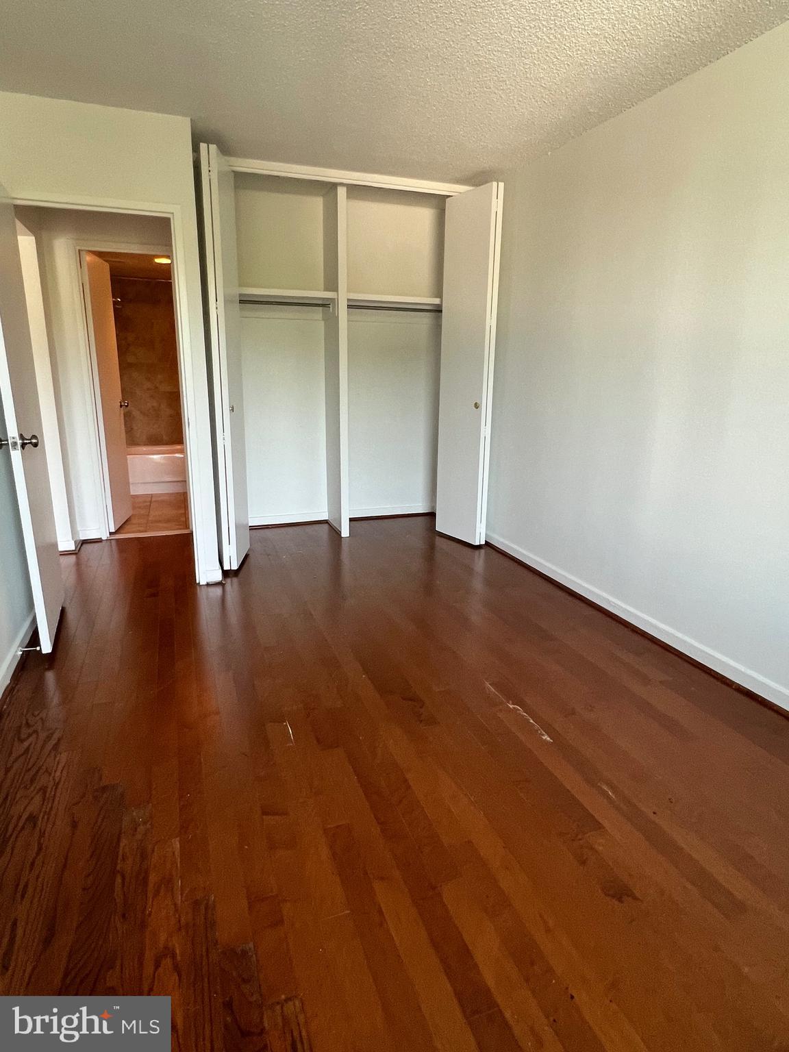 300 M Street Southwest, Unit N311 Washington, DC 20024 - Photo 6 of 9 an empty room with wooden floor and closet