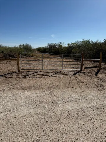 a view of a yard with wooden fence