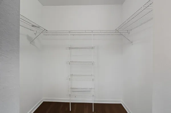 a view of walk in closet with empty racks