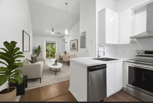a kitchen with a sink stove and cabinets