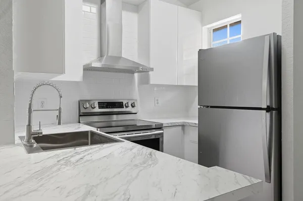 a kitchen with a refrigerator and a sink