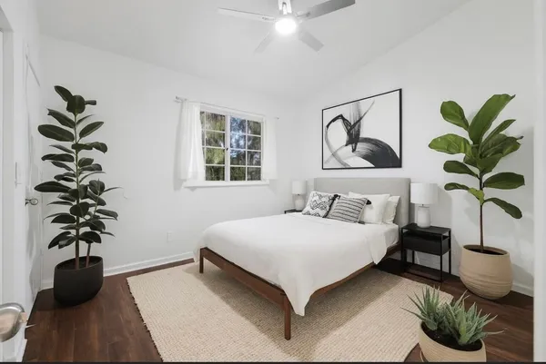 a bedroom with a bed potted plant with the window