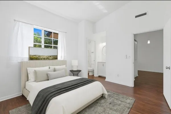 a bedroom with a bed and a window