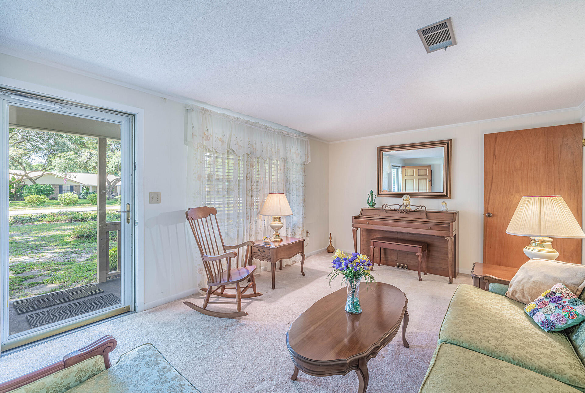 1709 Valparaiso Boulevard Niceville, FL 32578 - Photo 15 of 33 a living room with furniture a fireplace and a potted plant