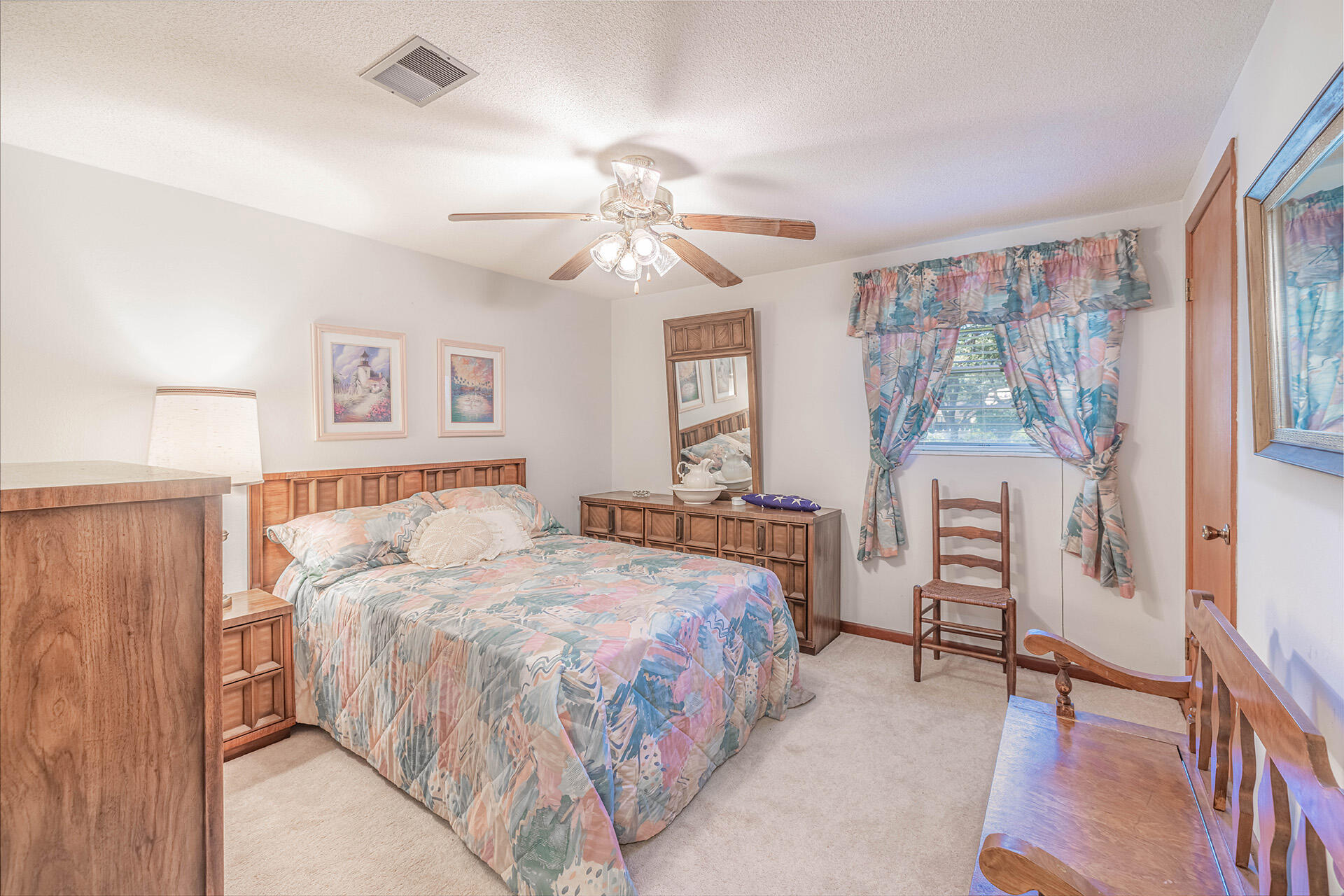 1709 Valparaiso Boulevard Niceville, FL 32578 - Photo 29 of 33 a bedroom with a bed and a chandelier