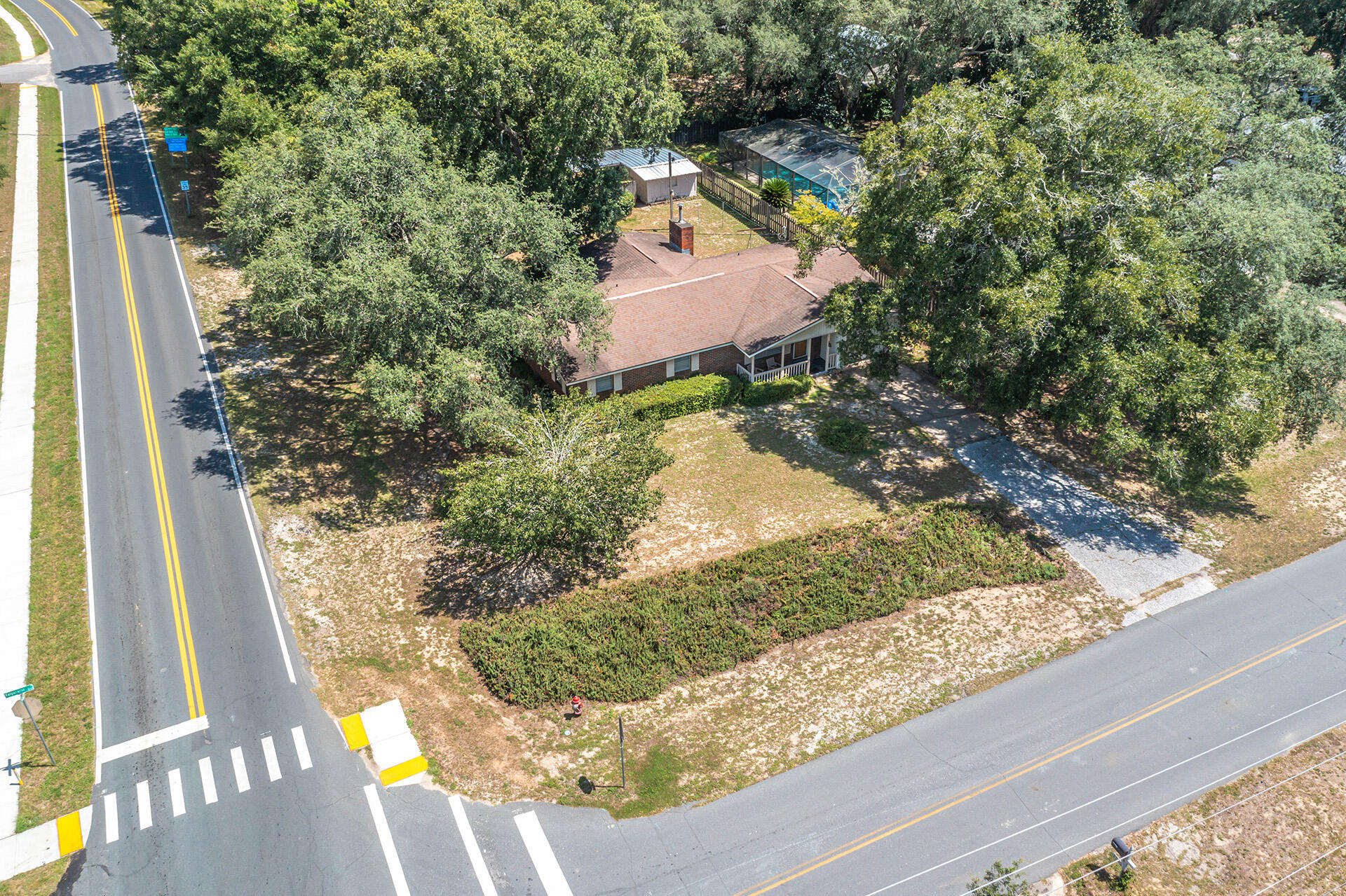 1709 Valparaiso Boulevard Niceville, FL 32578 - Photo 9 of 33 a picture of a yard with a house and a bench