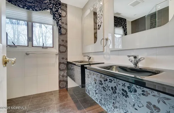 a kitchen with sink a window and cabinets