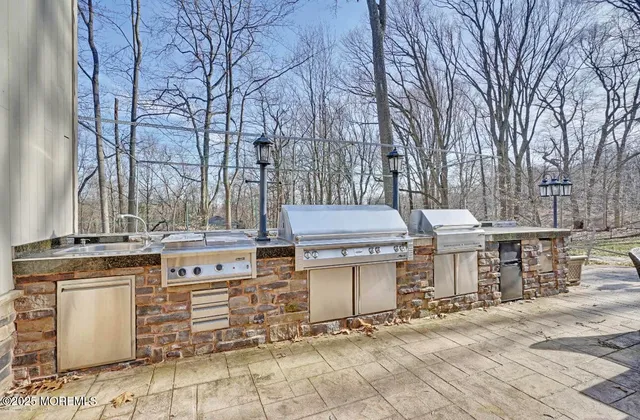 a view of a chairs and table in the back yard of the house