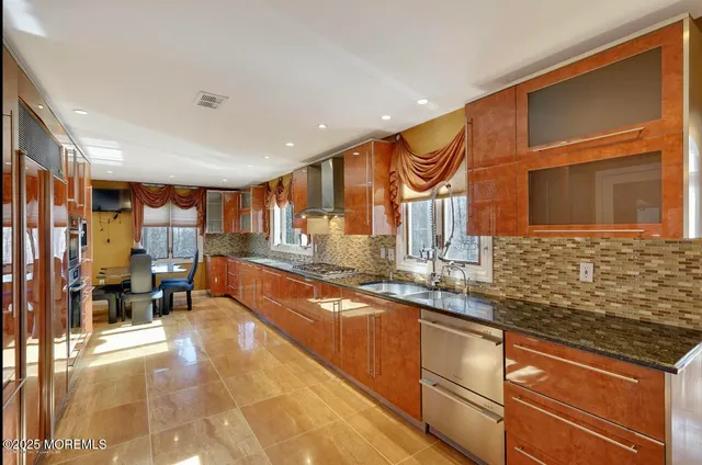 a kitchen with stainless steel appliances granite countertop a sink and cabinets