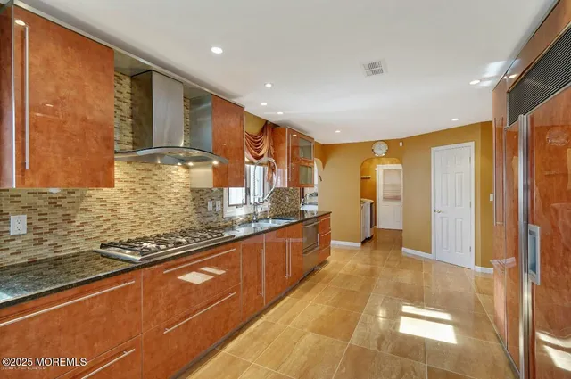 a large bathroom with a large mirror vanity and shower