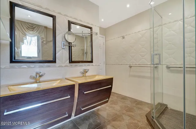 a bathroom with a double vanity sink mirror and double