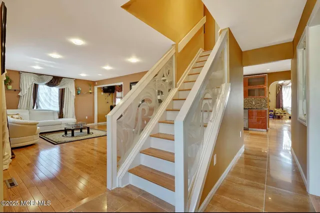 a view of entryway and hall with wooden floor