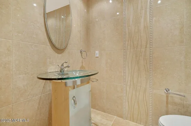 a bathroom with a sink a mirror and a shower