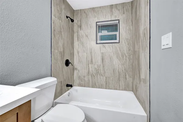 a bathroom with a toilet and a bathtub