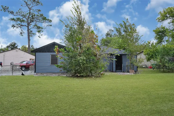a view of a house with a yard and sitting area
