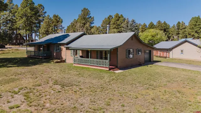 a living room with furniture a piano and windows