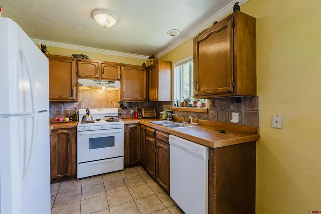 a view of a house with a yard and roof